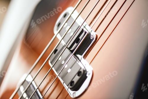 Preview: Guitar Structure. Close-up view of electric guitar body with metal strings and pickups