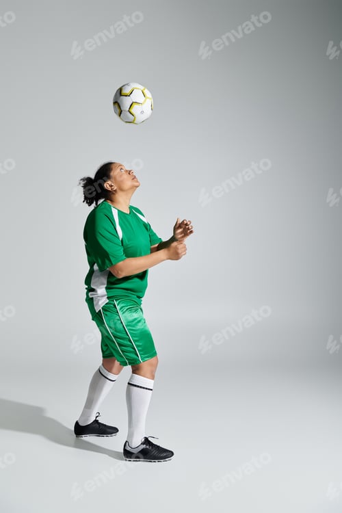 Preview: Athletic Woman Juggling Soccer Ball in Studio