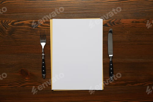 Preview: top view of blank card, fork and knife on wooden table