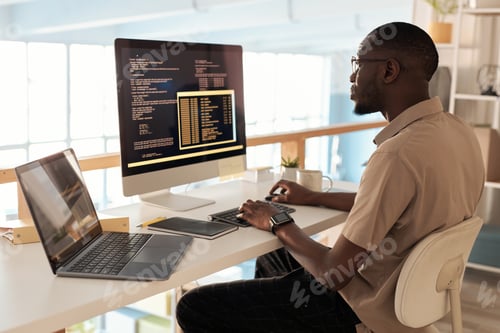 Preview: Programmer Working in Office