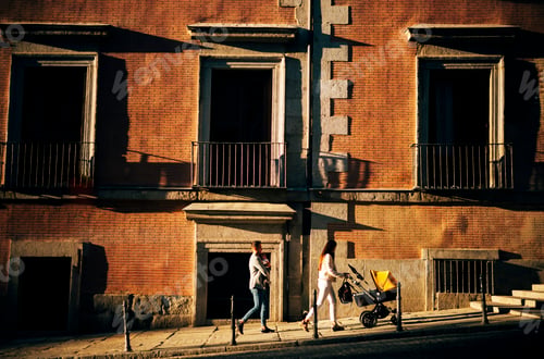 Preview: Couple walking with their baby