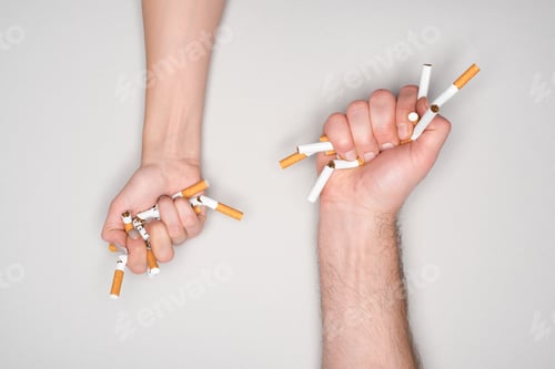 Preview: Partial view of woman and man breaking cigarettes isolated on grey, stop smoking concept