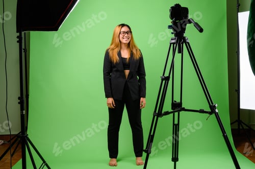 Visualização: Retrato de jovem empresária asiática contra fundo verde