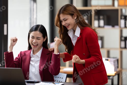 Preview: Excited concept, Happy young woman high fiving with colleague in office.