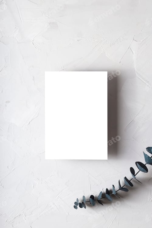 Preview: Mock up postcard on a gray background next to sprig of eucalyptus.