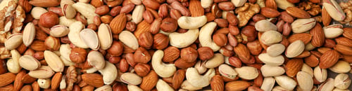 Preview: Different tasty nuts on towel, top view. Vitamin food
