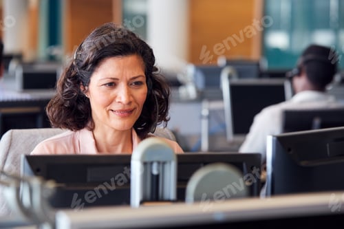Preview: Mature Businesswoman Wearing Telephone Headset Talking To Caller In Customer Services Department