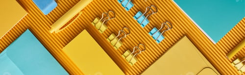 Preview: panoramic shot of arranged colorful office stationery supplies on yellow