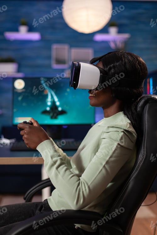 Preview: Concentrated african american streamer woman wearing virtual reality headset