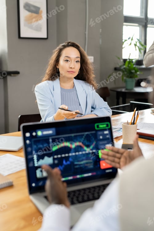 Preview: Confident businesswoman interacting with AFrican colleague