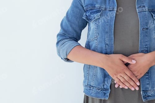 Preview: Closeup ill young woman on sofa. concept suffering from abdominal pain