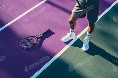 Preview: Cropped shot of person standing on tennis court