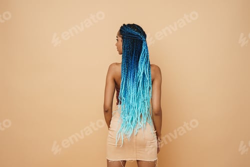 Preview: Young black woman with blue afro pigtails posing on camera