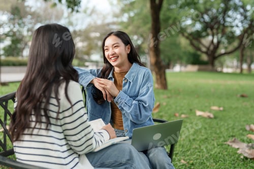 Preview: Young asian women friends discussing ideas in park