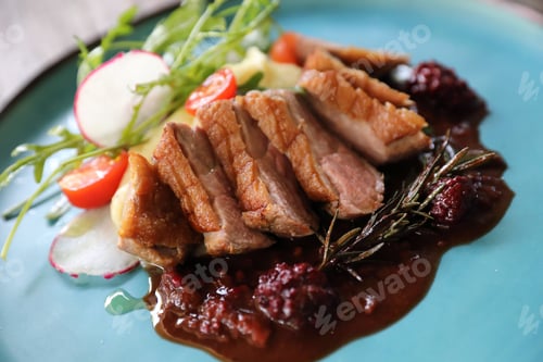 Preview: Duck Confit With Salad , Baked Apple And Raspberry Sauce Served On Wooden Table