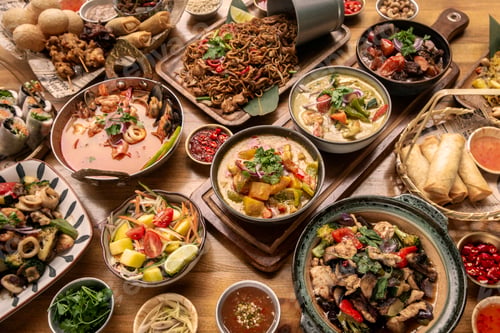 Preview: many different thai food dishes on table in modern restaurant in bangkok thailand