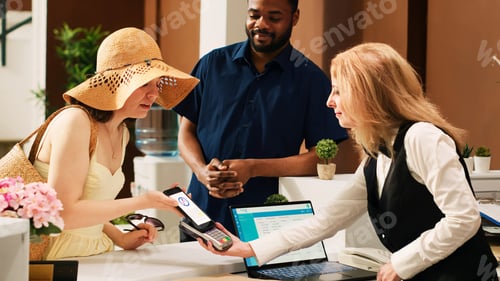 Preview: Diverse couple using mobile nfc payment