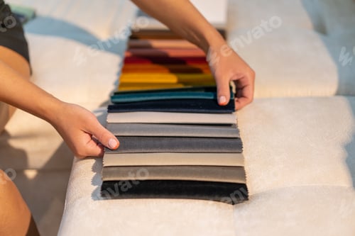 Woman selecting a fabric swatch at home