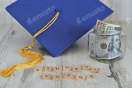 Preview: Graduation cap mortarboard with tassel propped on a jar of money cash, words STUDENT LOANS