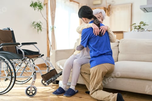 Preview: Asian caregiver assisting with transfer during home care visit