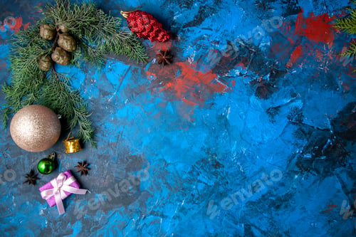 Preview: top view fir tree branches cones xmas tree toys on blue background free place