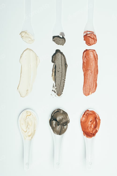 Preview: flat lay with spoons and various colorful clay mask smudges placed in row isolated on white surface