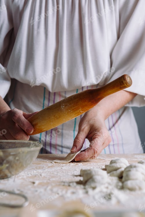 Preview: Making meat dumpling with wooden rolling pin.