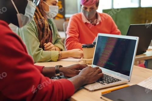 Preview: Hands of young it engineer of African ethnicity working over new program