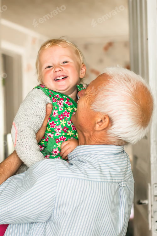 Preview: Grandfather plays with his little granddaughter. Happy old man lifted up a girl and smiles