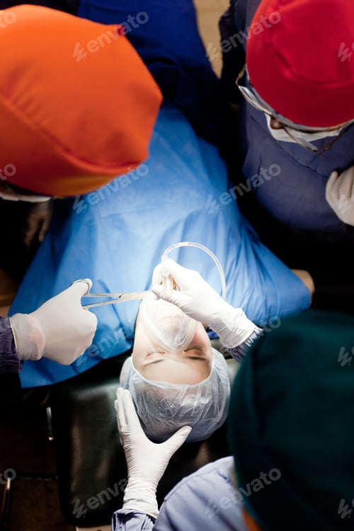Preview: Group Of Doctors Operating On A Female Patient