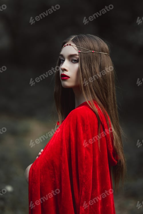 Preview: attractive mystic girl in red cloak and wreath in forest
