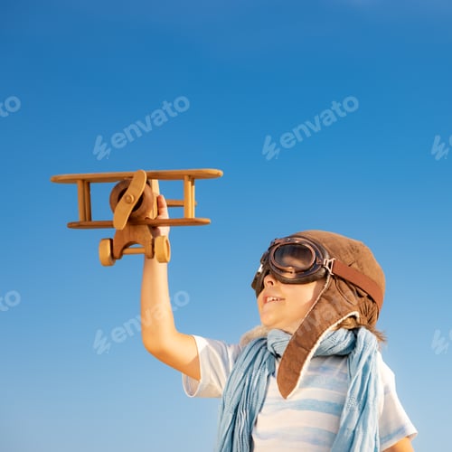 Preview: Smiling Child Holds a Wooden Airplane Toy