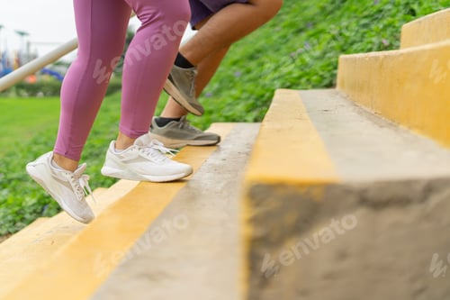 Preview: Legs of overweight people running up stairs in a park