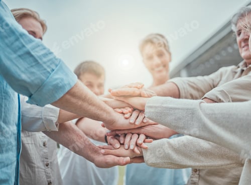Preview: Shot of a family stacking their hands in the garden outside