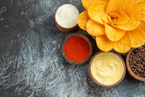 Preview: Horizontal view of homemade potato chips decorated like flower shaped and different spices