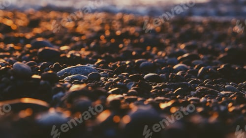 Preview: Beach pebbles in the evening light during sunset