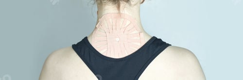 Preview: Female young caucasian athlete with therapeutic tape on neck wearing black tank