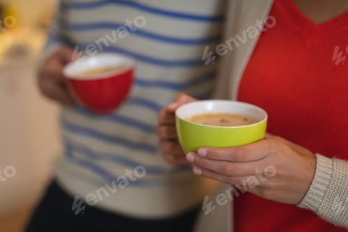 Preview: Young couple drinking coffee in the kitchen