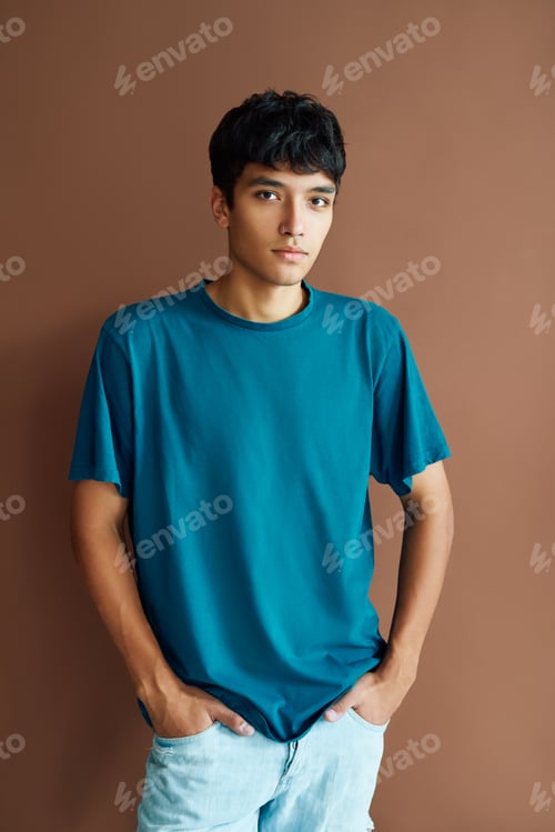 Preview: Young handsome mixed race man posing on studio background looking to camera