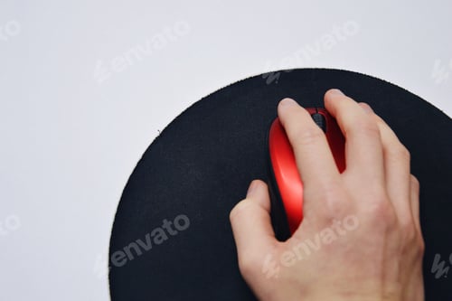 Preview: Overhead photo of a hand holding a red wireless computer mouse