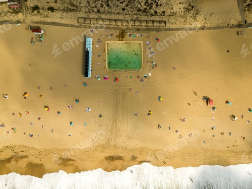 Preview: Aerial view of populated sandy coastline with splashing waves of sea
