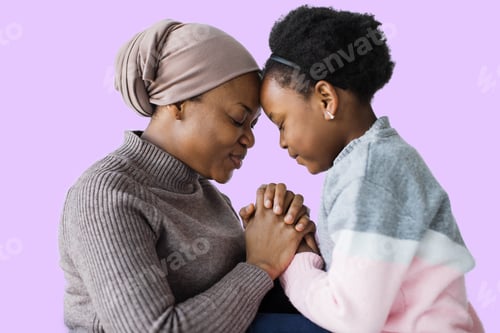 Preview: Mother and daughter holding hands and sitting head to head