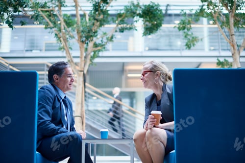Preview: Businesswoman and man at meeting in office atrium