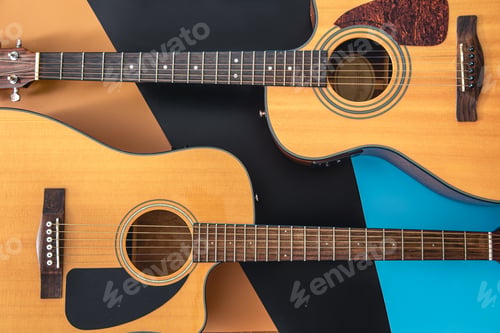 Preview: Two acoustic guitars on a colored background, flat lay.