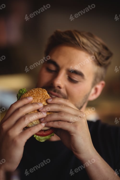 Preview: Close-up of man eating burger