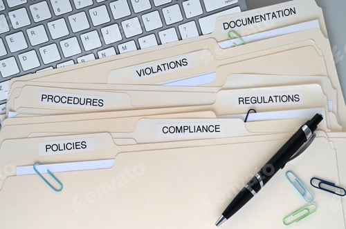 Preview: Compliance, Policies, Regulations, Violations, Procedures and Documentation folders on a desk
