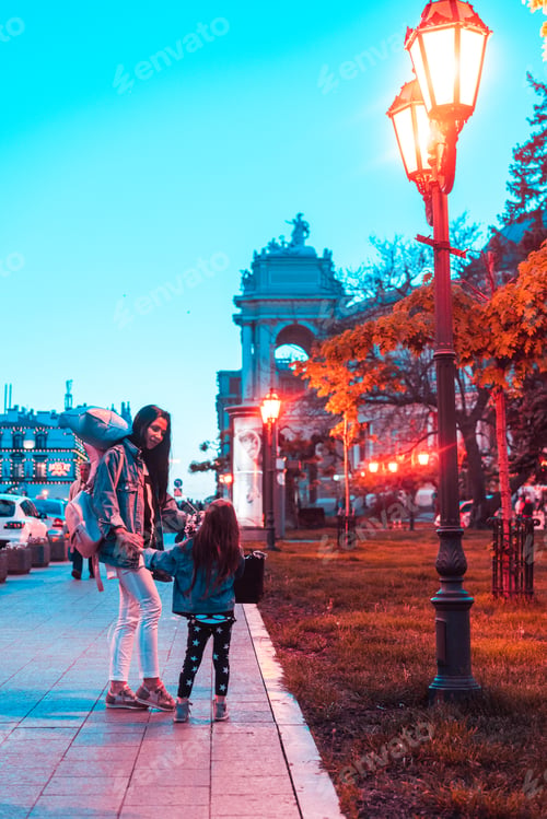 Preview: preschool girl and mother in the evening city
