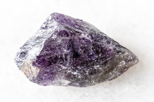 Preview: sample of raw amethyst mineral on white marble