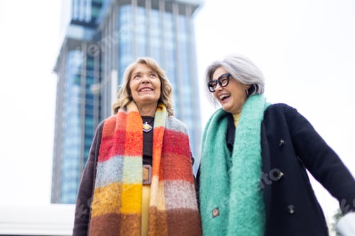 Preview: Stylish senior friends enjoying a happy moment in city