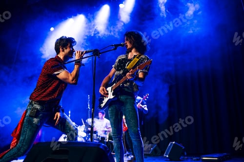 Preview: Rock and roll group performing live.